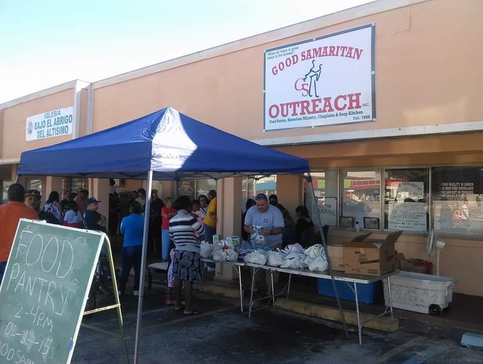 Volunteer listening to a community member during a Good Samaritan Outreach pantry distribution